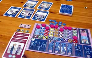 Close up of player mat, tokens and cards early on in the game