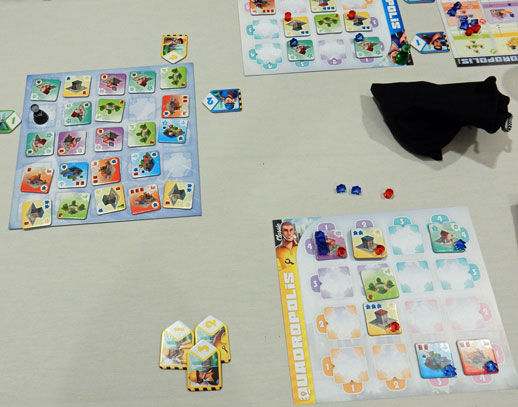 Starting the second round of Quadropolis with a few buildings on my board